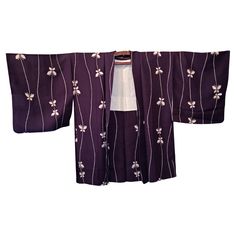 This is a silk jacket which was made in Japan. It was made in Showa era around 1980s. The haori is a traditional Japanese hip- or thigh-length jacket worn over a kimono. Resembling a shortened kimono with no overlapping front panels (okumi), the haori typically features a thinner collar than that of a kimono, and is sewn with the addition of two thin, triangular panels at either side seam. The haori is usually tied at the front with two short cords, known as haori himo, which attach to small loops sewn inside the garment. During the early 1800s, geisha in the hanamachi of Fukagawa, Tokyo began to wear haori over their kimono. Haori had until that point only been worn by men; the geisha of Fukagawa, well known for their stylish and unusual fashion choices, set a trend that saw women wearing Dark Purple Butterfly, Unusual Fashion, Pattern Japanese, Showa Era, Japanese Silk, Silk Jacket, White Butterfly, Purple Butterfly, Butterfly Pattern