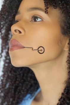 a woman with a nose tattoo on her face