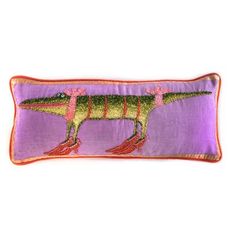 a purple pillow with an image of a dinosaur on the front and bottom, along with red trimmings