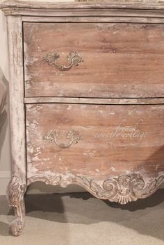 an old wooden dresser with writing on the drawers and drawer knobs is shown in this image