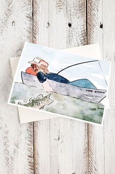 a greeting card with a watercolor painting of a man on a surfboard