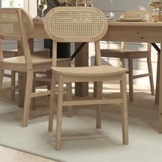 a dining room table and chairs in front of a vase with flowers on top of it