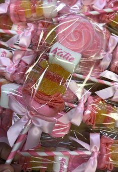 pink and yellow candies wrapped in clear cellophane with ribbon around the edges