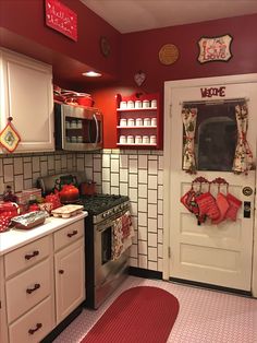 the kitchen is decorated in red and white