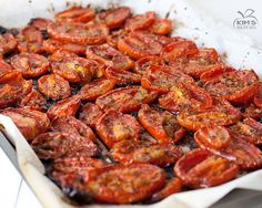 a pan filled with cooked tomatoes on top of a table