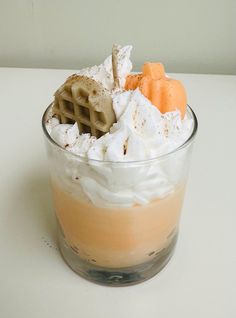 a dessert in a glass with whipped cream and pretzel toppings on top