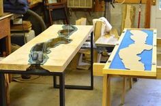 the table is made out of plywood and has glass top with blue waves on it