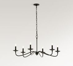 a black chandelier with five lights hanging from it's center and four arms