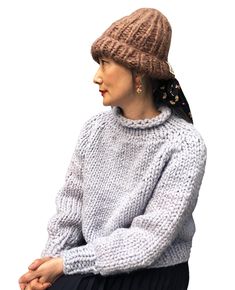 a woman wearing a knitted hat and sweater