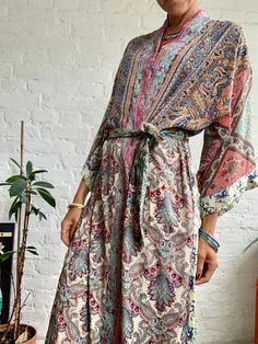 "This is super stylish kimono robe made free size with wrap tie closing  easy fit all ladies, feels very comfortable and light  Can be used as an everyday robe or boho street style over all with jeans and t shirt  It is made one of a kind, patchwork from varieties of different floral silky materials  MEAESURE shoulder 17\" length 55\" MATERIAL *poliester and * no lining more available at  https://www.etsy.com/shop/AltheaStores? CARE INSTRUCTIONS  * Wash in warm water * Hand wash recommended * Ha Bohemian V-neck Robe For Loungewear, Bohemian Kimono With Tie Waist And Kimono Sleeves, Flowy Silk Maxi Length Kimono, Bohemian Tie-waist Maxi Dress Beach Cover-up, Bohemian Tie Waist Maxi Dress For Beachwear, Bohemian Tie Waist Maxi Dress As Beach Cover-up, Bohemian Tie Waist Maxi Dress For Beach Cover-up, Bohemian Wrap Robe With Flowy Fit, Bohemian Silk Wrap Dress