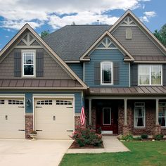 a house with two garages and an american flag