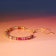 Sparkling in spectrum rainbow colors, this tennis bracelet will never be out of fashion. The lively gradation goes from crimson, fuchsia, pink, light blue, navy blue, emerald green to peridot green, giving the bracelet a playful and dainty effect. Collect the transient rainbow in the sky on your wrist, and carry it wherever you go, because it brings you luck and joy. The graceful and timeless color combination makes it a perfect accessory for women of all ages. Carat Weight: 10.142 ctStone Size: Adjustable Pink Jubilee Tennis Bracelet, Silver Tennis Bracelet, Blue Emerald, Rainbow Sky, Peridot Green, Fuchsia Pink, Pink Light, Tennis Bracelet, Color Combination