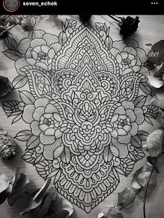 a black and white photo of an intricately designed piece of art on the floor