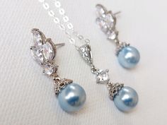 This is a RESERVED listing for Special Customer! Wedding Light Blue Blush Blue Pearl Cubic Zirconia Silver Dainty Bridal Earrings and Necklace Jewelry Set with .925 Sterling Silver Chain. EARRINGS are 1.06 inch (2.7cm) long from top of erring stud to bottom. CHAIN is 24 inches long. PENDANT is about 1.06 inch (2.7cm) including bail. Elegant and timeless, these dainty jewelry set is perfect for weddings or special occasions such as birthdays, anniversaries, graduations, proms...or whatever you ca Blue Wedding Jewelry With Matching Earrings, Elegant Light Blue Jewelry For Party, Blue Round Jewelry Sets For Wedding, Elegant Blue Dangle Jewelry Sets, Light Blue Teardrop Jewelry For Wedding, Elegant Light Blue Jewelry For Wedding, Blue Pearl Jewelry, Pearl Silver Jewelry, Wedding Light Blue