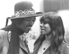 the man and woman are standing close together wearing hats with rings on their foreheads