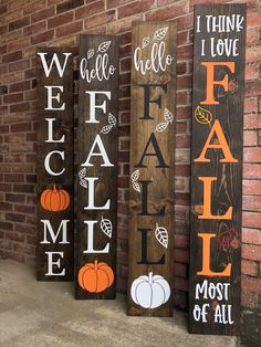 three wooden signs that say fall and have pumpkins on them