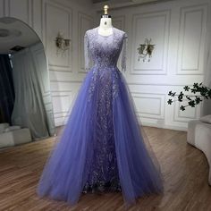 a dress is displayed on a mannequin in a room