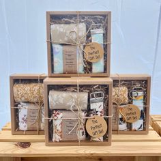 three wooden boxes filled with different types of items