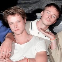 three young men sitting next to each other