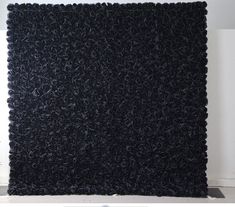 a large black rug sitting on top of a white floor