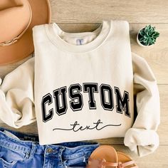 Custom Text Sweatshirt Vintage College Letters Sweatshirt Gift Retro Oversized Sweater Personalized Add Your Own Text Custom Quote Varsity Plus sizes also available: 2X, 3X, 4X, 5X -------- HOW TO ORDER -------- 1) Select your sweatshirt Size 2) Select your desired Color 3) Add personalization. 4) Click "Add to Cart" and place your order. 5) Repeat for more items. Ideal for any situation, a unisex heavy blend crewneck sweatshirt is pure comfort. These garments are made from polyester and cotton. Oversized White Varsity Sweatshirt, White Oversized Varsity Sweatshirt, Oversized White Letter Print Sweats, White Oversized Sweats With Letter Print, Oversized T-shirt With Ribbed Cuffs For College, Oversized College Sweater With Letter Embroidery, Oversized Crew Neck Top With Letter Embroidery, Oversized Letter Embroidery Sweater For College, Oversized Crew Neck Hoodie With Lettering