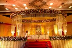 a mandap decorated with flowers and candles