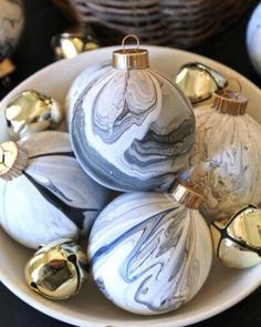 a bowl filled with white and silver ornaments