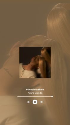 a woman with long blonde hair is kissing a man's head in front of her