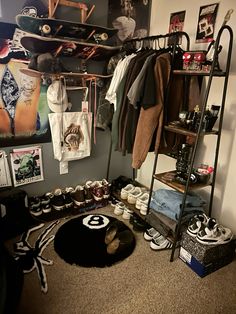 a room filled with lots of shoes and clothes hanging on the wall next to a shelf