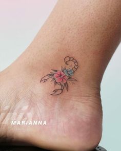 a small flower tattoo on the foot