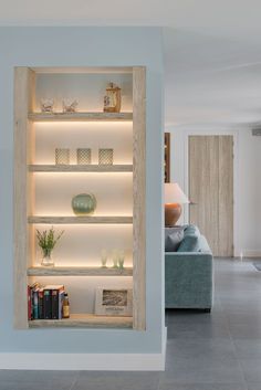 an open book shelf in the middle of a living room