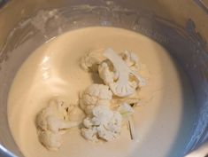 cauliflower florets are in a silver bowl