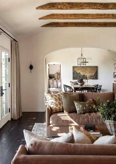 a living room filled with furniture and lots of windows