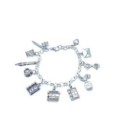 "New. This Bracelet makes a perfect gift. Has  12 Writer Journalist Themed Charms all charms are approx 1/2\" to 1\" in size Stainless Steel bracelet has a lobster clasp closure and is adjustable measures approx 8\" bracelet is Stainless Steel  charms are silver tone alloy and steel. (Nickel and lead free) charms include Book, Pencil, Memo Pad, Fountain Pen, Cup Of Coffee, A true Story Book, Typewriter, Once Upon A Time Book, Quill and Ink Well, Eye Glasses, Envelope, Small puffy Heart" Adjustable Themed Charms Jewelry, Themed Adjustable Jewelry With Dangling Charms, Adjustable Themed Jewelry With Dangling Charms, Adjustable Hypoallergenic Metal Charms, Adjustable Vintage Charm Bracelets As Gift, Adjustable Sterling Silver Charm Bracelet With Lobster Clasp, Adjustable Symbolic Metal Charms, Adjustable Themed Metal Charms, Adjustable Nickel-free Metal Charms