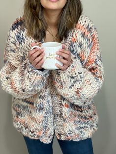 a woman holding a coffee cup in her hands