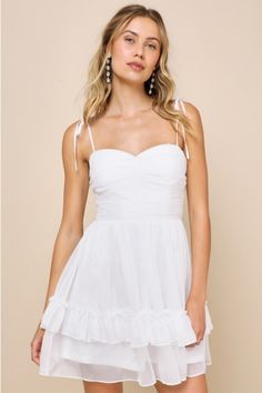 There's simply nothing sweeter than a babe like you wearing the Lulus Angelic Approach White Chiffon Ruffled Tie-Strap Mini Dress! Ultra-floaty lightweight chiffon shapes this darling dress that has tying spaghetti straps and a ruched and gathered bodice with a sweetheart neckline. Fitted waist tops a tiered skirt with sweet ruffled trim, finishing at a mini hem. Hidden zipper/clasp at back. Fit: This garment fits true to size. Length: Mid-thigh. Size medium measures 26.5" from adjustable straps Tiered Mini Dress, White Ruffle Dress, White Homecoming Dresses, White Chiffon, Chiffon Ruffle, Darling Dress, Ruffle Mini Dress, Sweetheart Neckline, Ruffle Dress