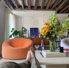 a person laying on the floor with their feet up in front of a coffee table