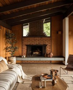 a living room filled with furniture and a fire place in the middle of a room