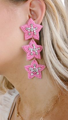 Add some sparkle and shine to your day with these cute pink beaded earrings! Featuring a star shape and tons of shimmer, dollys world earrings are sure to make you star of the show. And the best part? They won't break the bank—stellar style for a stellar price! NOT available for in store credit or exchange (see policy for more info) filter used to brighten color Pink Star Earrings For Party, Pink Star-shaped Party Earrings, Pink Star-shaped Jewelry For Party, Pink Star Charm Dangle Earrings, Pink Dangle Earrings With Star Charm, Pink Star Charm Jewelry, Cute Pink Beaded Dangle Earrings, Cute Pink Dangle Beaded Earrings, Star-shaped Beaded Jewelry For Party