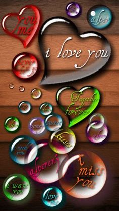 the words i love you are surrounded by hearts and bubbles on a wooden surface with water droplets