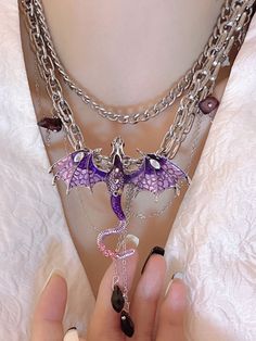 This choker is made of alloy and is decorated with a black and red dragon or a purple dragon, along with tassels. It features a unique and eye-catching design that adds a touch of edgy style to any outfit. Perfect for those who love to make a bold fashion statement, this choker is a must-have accessory for any kawaii or lolita look. The dragon motif adds a mystical and whimsical touch, making it a standout piece for any occasion.  The price is for a choker only, others are not included. Trendy Metal Jewelry For Cosplay, Edgy Purple Jewelry For Gifts, Edgy Purple Jewelry For Gift, Edgy Purple Jewelry As Gift, Purple Metal Jewelry For Halloween, Black And Red Dragon, Dragon Motif, Steampunk Fashion Male, Tassel Earing