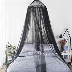 a bed with a black mosquito net over it