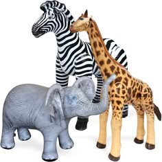 three toy zebras and two giraffes standing next to each other