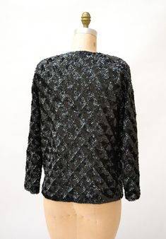 "Amazing Vintage Sequin Jacket Features: * fully embellished with black onyx sequins on wool body with woven lining * Basic neckline with long sleeves * Relaxed fit * great statement piece * Black lining and front hook and eye closure No Brand Sweater knit wool with synthetic lining Size 40, Fits like a Medium Era most likely the 50/60s In great condition, Beautiful jacket! Bust 40\" Bottom opening 39\" Body length from Shoulder seam 24\" Sleeve length from neck seam 27\" (can be taken out 1\") Vintage Formal Outerwear With Sequins, Vintage Sequined Formal Outerwear, Vintage Formal Sequined Outerwear, Long Sleeve Evening Cardigan For Winter, Winter Evening Long Sleeve Cardigan, Long Sleeve Cardigan For Evening In Winter, Black Sequined Evening Outerwear, Elegant Winter Cardigan With Sequins, Vintage Winter Outerwear With Sequins