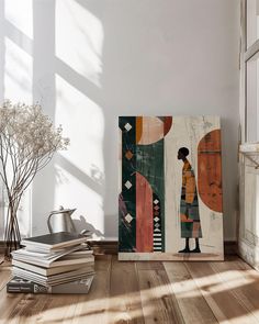 a stack of books sitting on top of a wooden floor next to a vase with flowers