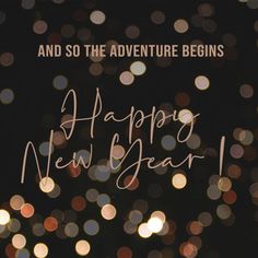 the words and lights are blurry in the background, which reads happy new year and so the adventure begins