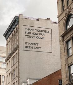 a sign on the side of a building that says thank yourself for how far you've come it hasn't been easy