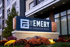 the entrance sign for the emery at overlook ridge in front of an office building