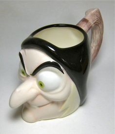 a close up of a ceramic cup with a bird on it's head and nose