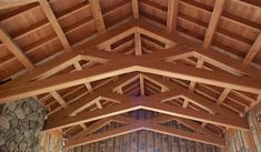 the inside of a building with wooden beams